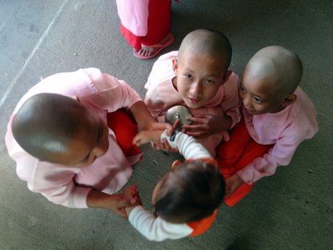 child nuns holding baby by the hands