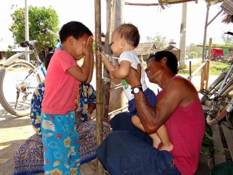 European baby playing with the locals of Myanmar