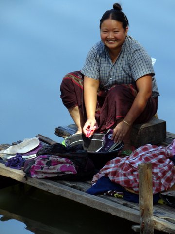 Lady washing by river in Myanmar