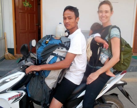 On a motorcycle with the baby and a backpack in Myanmar
