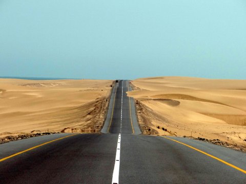 road separating desert and beach