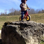 small child on a slider on top of rock, an ode to Nicolai
